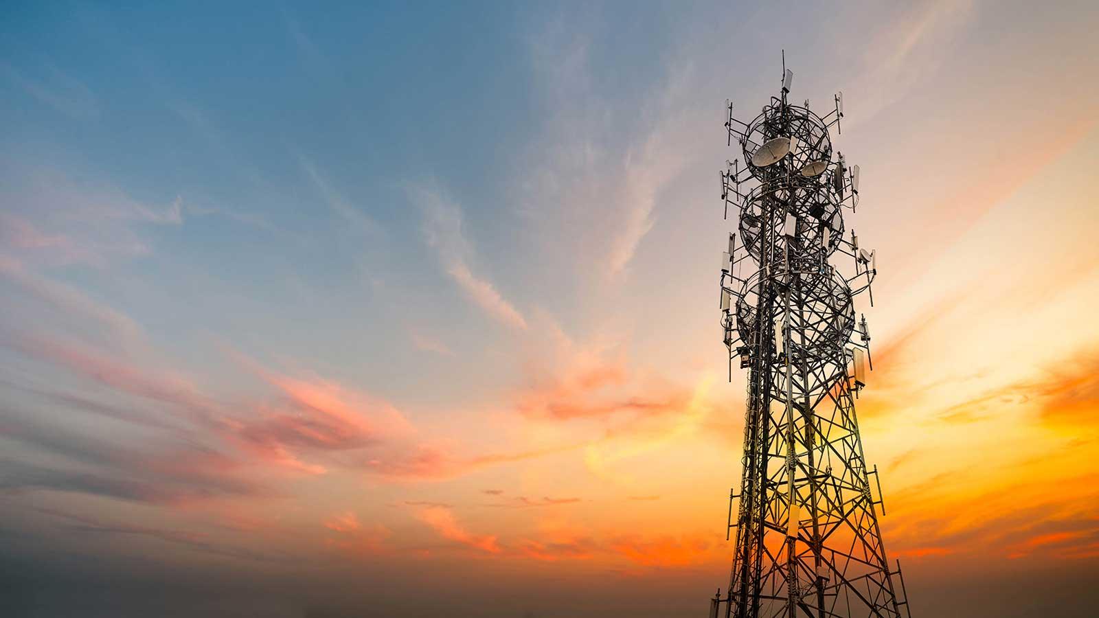 Communications tower at sunset representing Electrical Engineering programs at Clarkson University